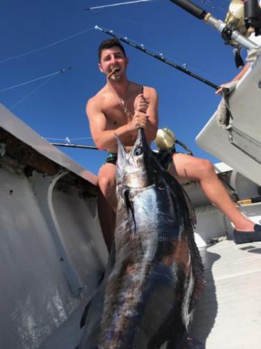 Man with huge marlin he caught while deep sea fishing